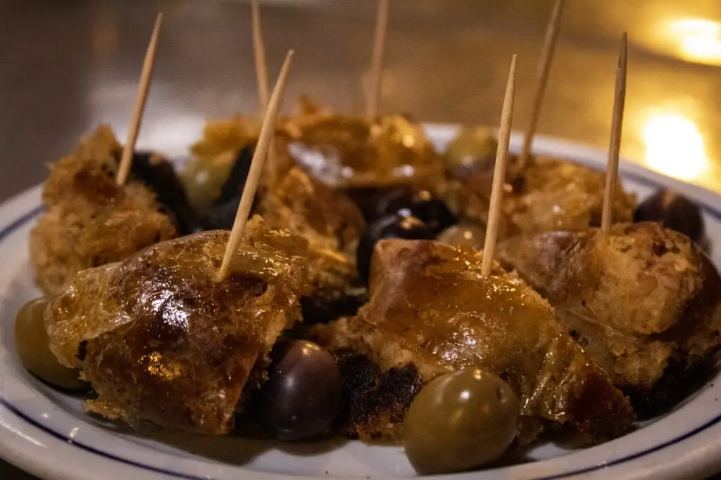Alheira and Olives - A popular Portuguese Snack that you can try on COME Food Tours